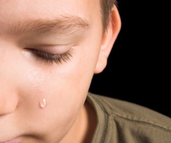 young boy crying - Childrens books on death