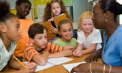 list of character traits - group of kids attentively listening to teacher