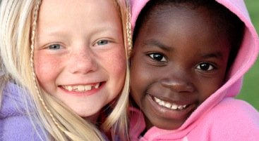 making friends-2 young girls smiling broadly